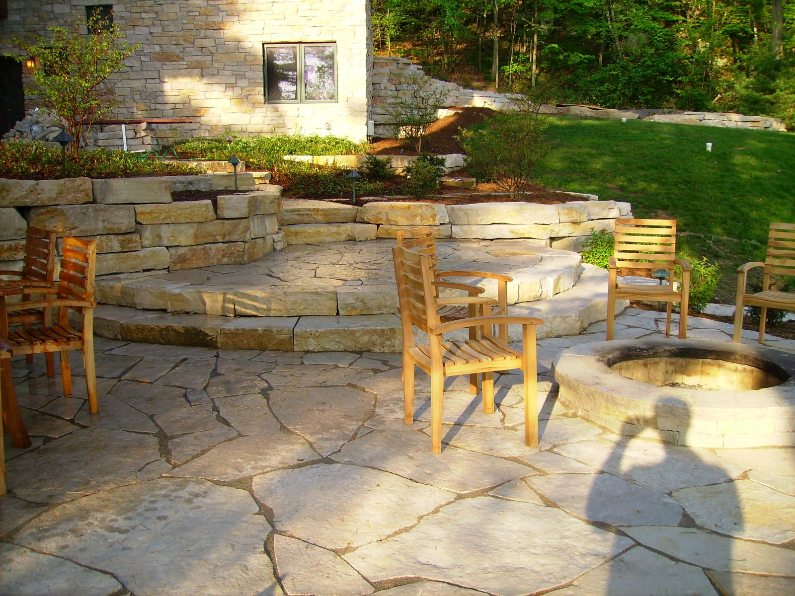 Limestone retaining walls, patio, steps and fire pit in Mequon, WI