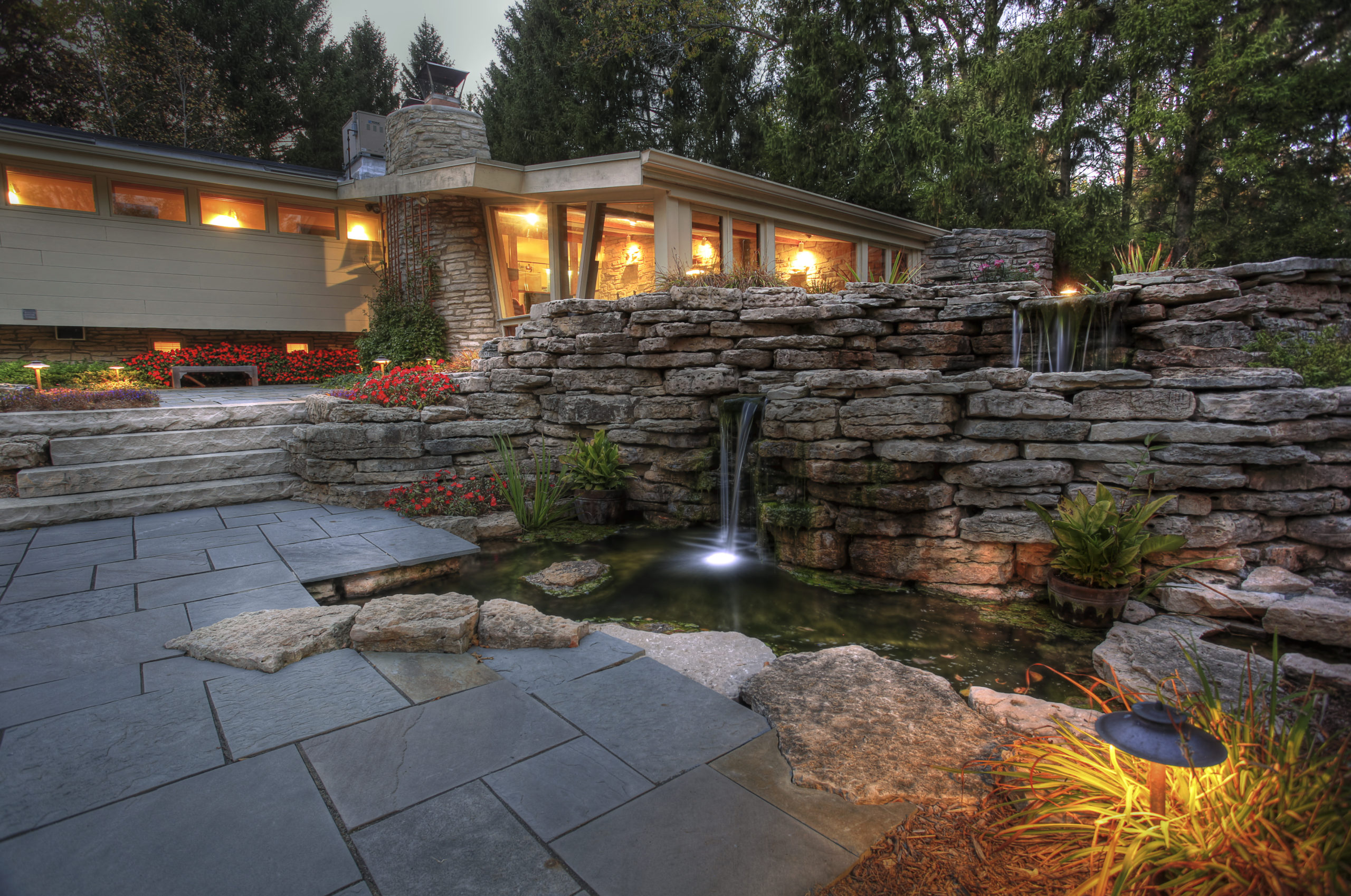 Landscape project in Mequon including patio, steps, water feature (pond, waterfall and stream) and landscape lighting.