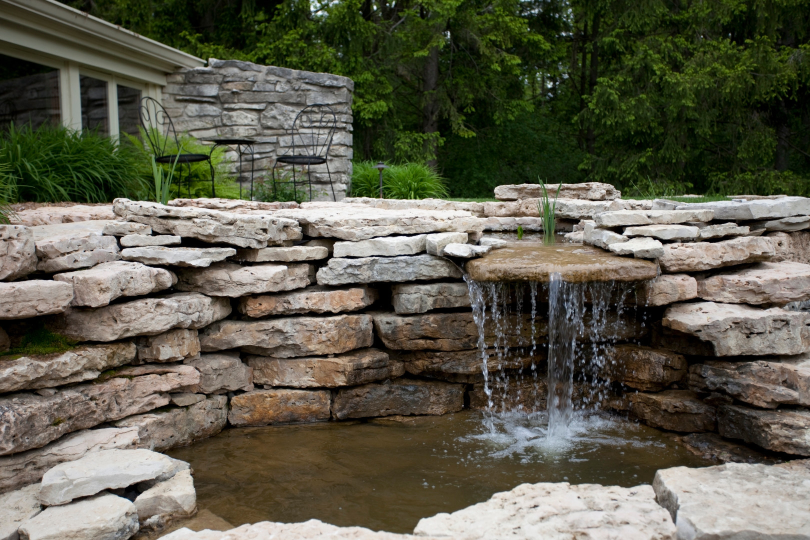 This landscape in Mequon includes a water feature with pond, stream and waterfall.