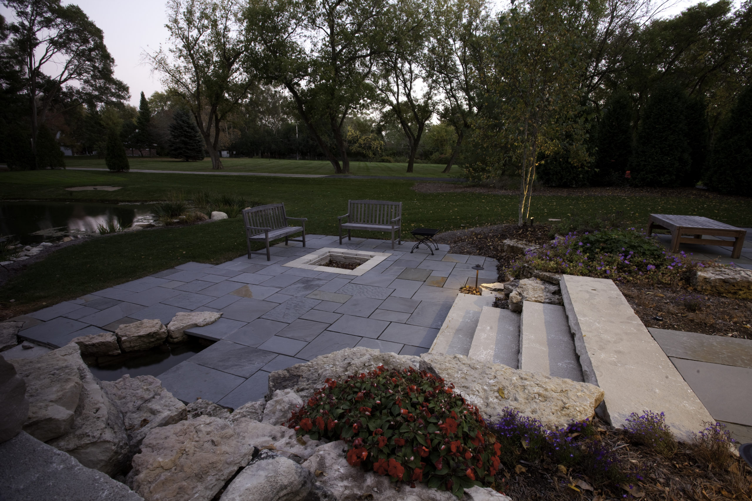 New York bluestone patio with Eden limestone fire pit and steps.